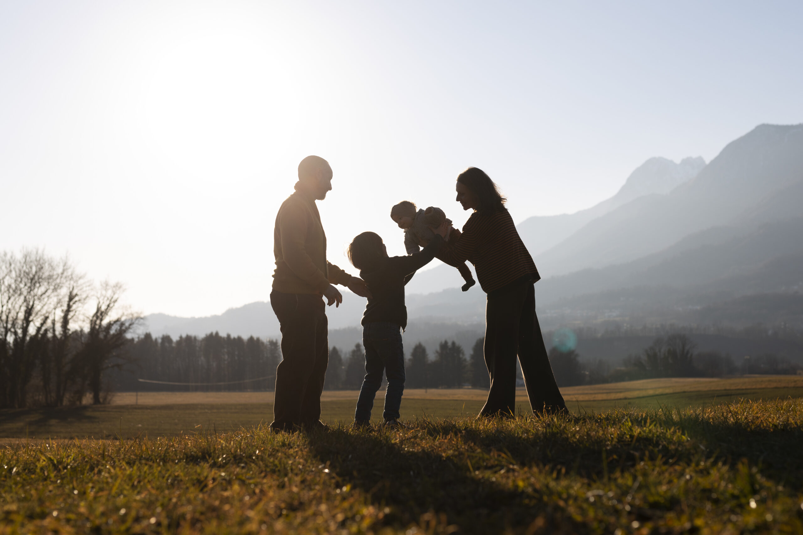 full-shot-family-silhouette-nature-sunset